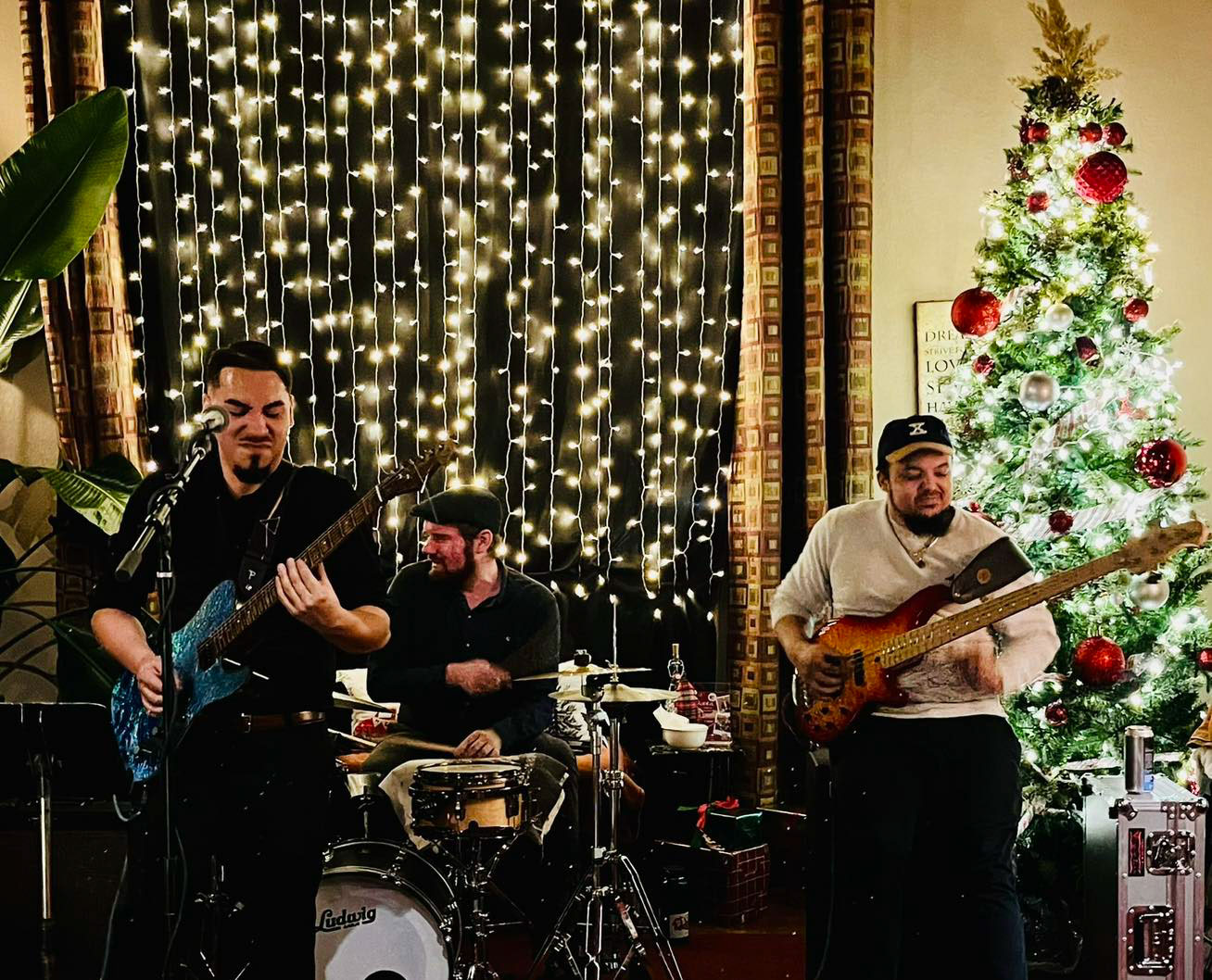 Three-piece band performing live at a Christmas event