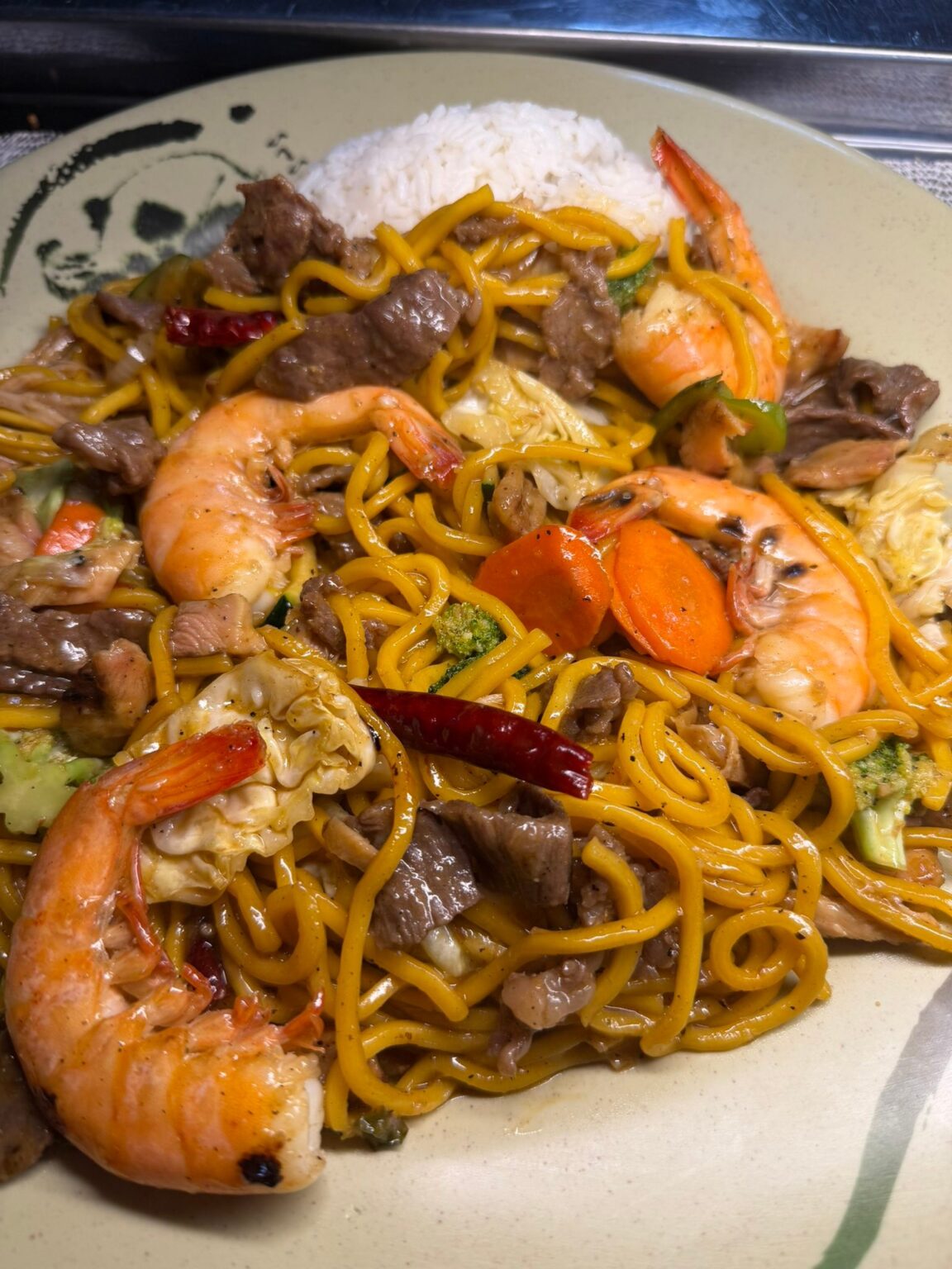 Stir-fried noodles with shrimp, beef, and vegetables